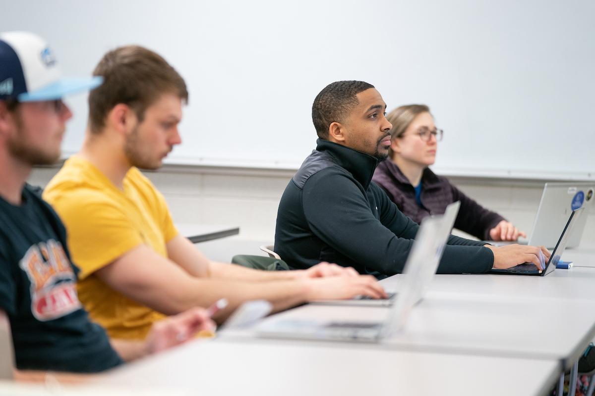 Students at laptops in a clasroom